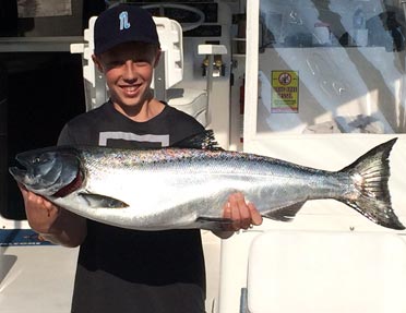 smiling-ten-year-old-with-trophy-salmon-caught-lake-michigan