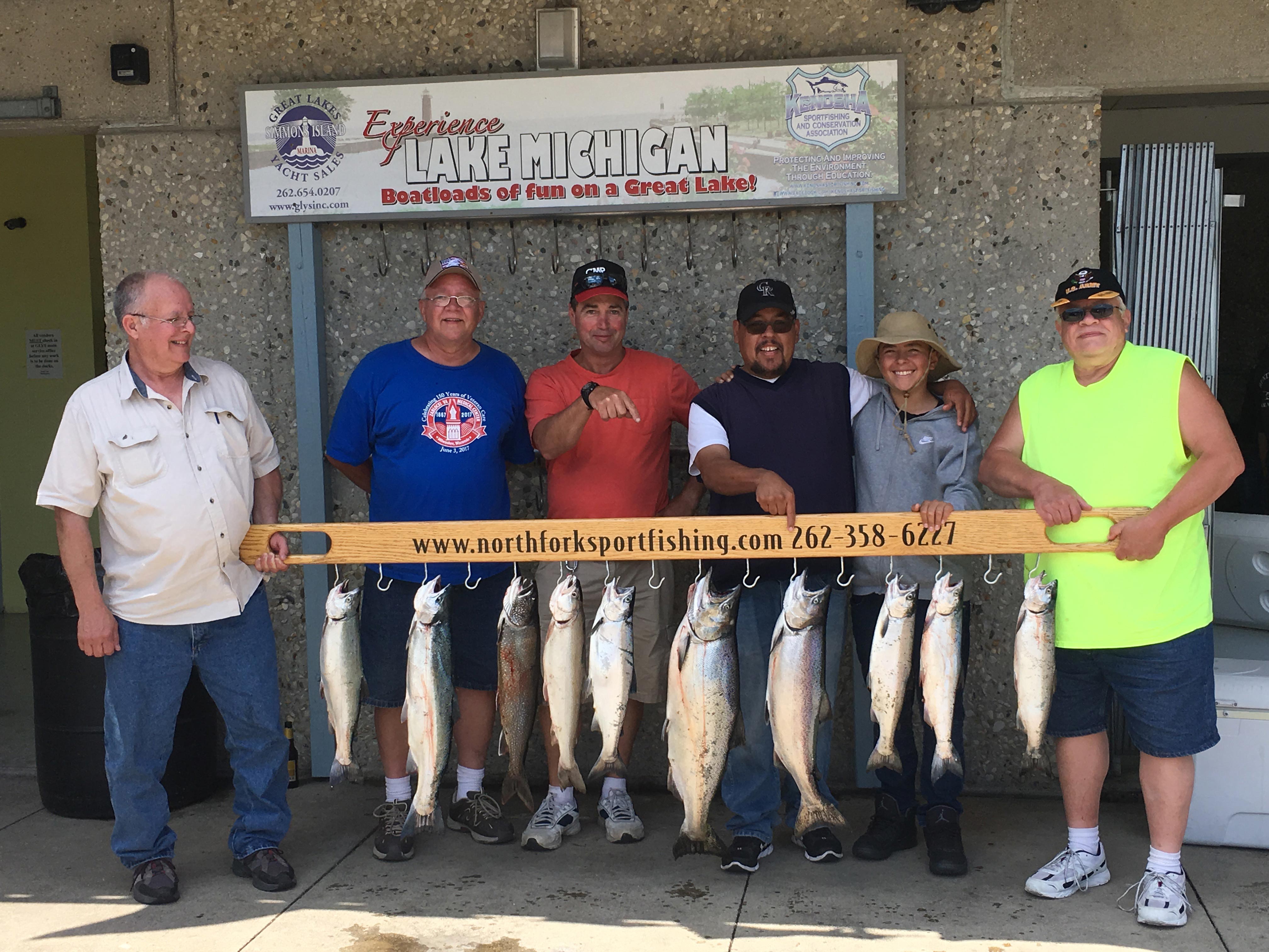 fishing-group-holding-what-they-caught-on-lake-michigan